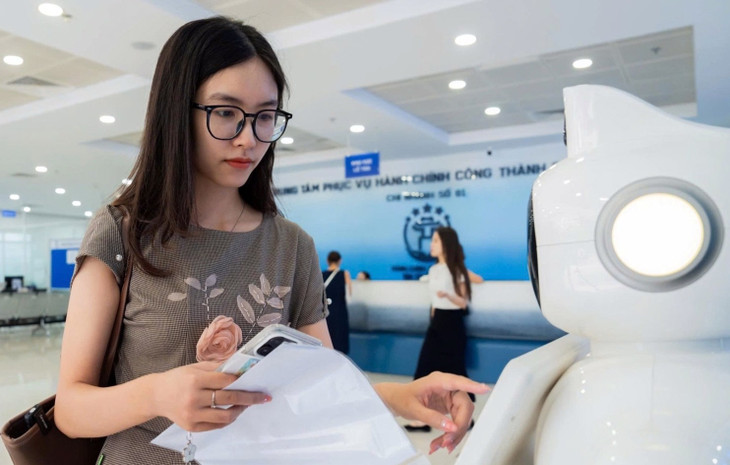 Người đến làm thủ tục hành chính sử dụng robot tại Trung tâm hành chính công số 1. 03-1.jpg