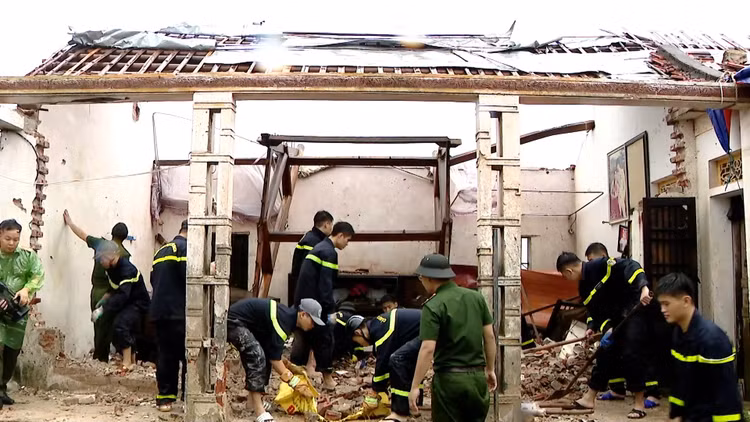 Các chiến sĩ Công an đang hỗ trợ người dân khắc phục hậu quả do Bão số 10 gây ra