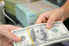 Giá USD tại Vietcombank sáng nay 12/8 không đổi. Ảnh minh họa: TTXVN