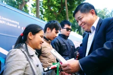 Bộ trưởng Bộ Kế hoạch và Đầu tư Nguyễn Chí Dũng trao gậy trắng cho người khiếm thị. Ảnh: Lê Tiên