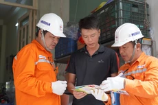 Các công nhân Công ty Điện lực Duyên Hải tuyên truyền người dân sử dụng điện an toàn mùa mưa bão