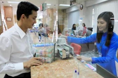 Tỷ giá USD sáng nay tăng mạnh. Ảnh minh họa: TTXVN