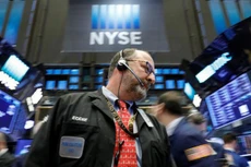 Một nhà giao dịch cổ phiếu trên sàn NYSE ở New York ngày 26/2 - Ảnh: Reuters.