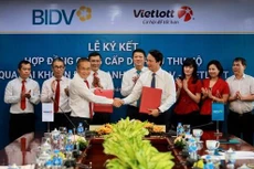 Ông Trần Long - Phó Tổng Giám đốc BIDV (bên phải) và ông Võ Quang Vinh - Phó Tổng Giám đốc Vietlott, đại diện hai bên ký kết hợp đồng