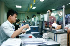 Hàng nghìn điều kiện kinh doanh vẫn còn tồn tại đang tạo nhiều rào cản hành chính, làm giảm sức cạnh tranh của môi trường đầu tư, kinh doanh. Ảnh: Nhã Chi