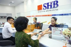 Vay vốn ngân hàng để phục vụ sản xuất, kinh doanh là hoạt động phổ biến của các doanh nghiệp tại Việt Nam. Ảnh: Nhã Chi