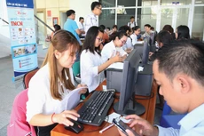 Chính phủ giao Bộ Tài chính nghiên cứu, hoàn thiện quy định về mức giảm trừ gia cảnh trên cơ sở đánh giá các tiêu chí, yếu tố tác động đến thu nhập của người nộp thuế. Ảnh: Hoàng Hà