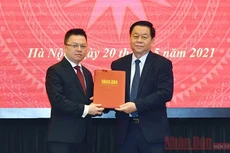 Trưởng Ban Tuyên giáo Trung ương Nguyễn Trọng Nghĩa trao Quyết định của Bộ Chính trị phân công ông Lê Quốc Minh giữ chức vụ Tổng Biên tập Báo Nhân Dân. Ảnh: Duy Linh