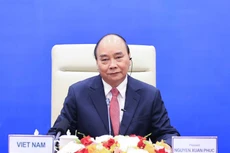 Chủ tịch nước Nguyễn Xuân Phúc chia sẻ về nỗ lực của Việt Nam trong thực hiện “mục tiêu kép” về phòng, chống dịch bệnh và duy trì tăng trưởng kinh tế. Ảnh: VGP