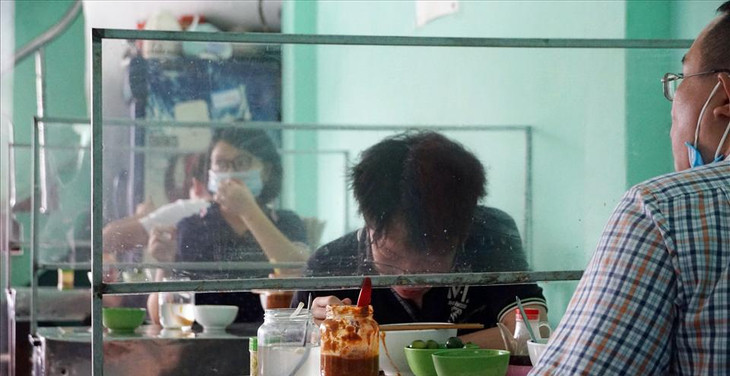 Các khách hàng trong nhà được bố trí giữ khoảng cách, các bàn đều được trang bị màn chắn đảm bảo an toàn cho mọi người.