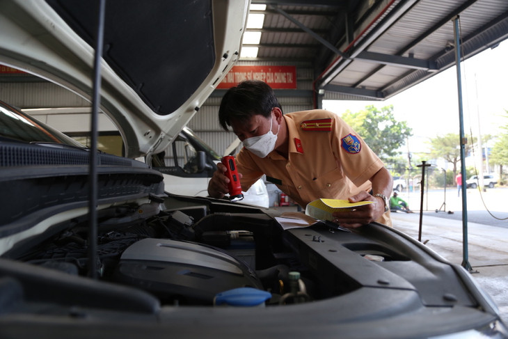 Cảnh sát giao thông đối chiếu thông số kỹ thuật của lốc máy ôtô khi đăng kiểm