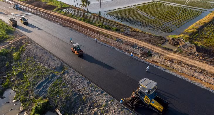 Khi đảm bảo điều kiện kỹ thuật, việc thảm nhựa tiếp tục được đẩy nhanh tiến độ để kịp hoàn thành trong tháng 11. Trong ảnh, công nhân thảm nhựa đoạn qua thị xã Cai Lậy.