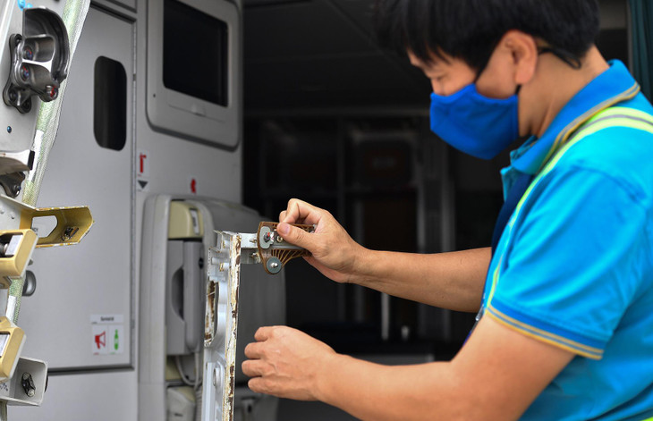 Nam nhân viên sửa chữa máy bay cho biết, anh đang tháo vệ sinh những bộ phận đã bị hoen gỉ sau thời gian dài chiếc tàu bay A350 này không hoạt động.