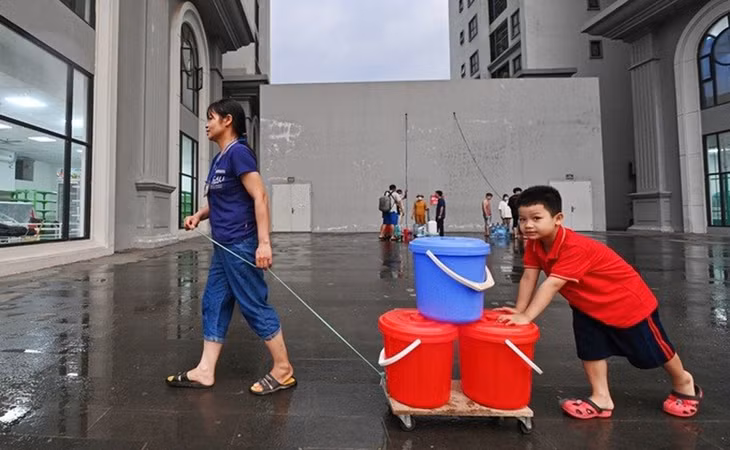 Người dân sinh sống tại địa bàn quận Nam Từ Liêm, Hà Nội chờ lấy nước sạch