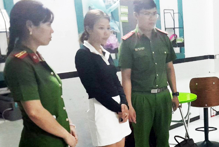 Nguyễn Thị Tuyết Nhung (áo đen) khi cảnh sát đọc lệnh bắt