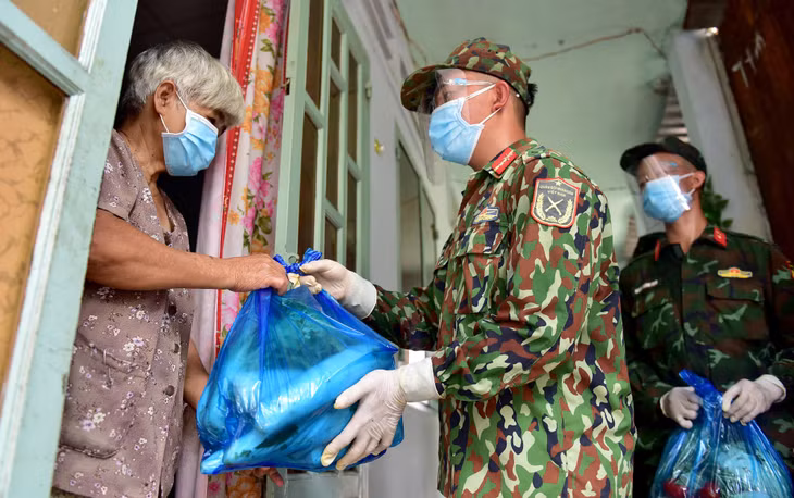 Trao túi quà đến tay người dân, tiểu đội trưởng Nguyễn Nhật Hòa liên tục động viên bà con cố gắng giữ gìn sức khỏe, nên ở yên trong nhà trong thời gian này. "Khi thấy bà con mừng vì nhận được phần quà hỗ trợ chúng tôi cũng cảm thấy vui, hy vọng sẽ giúp đỡ được mọi người cùng vượt qua dịch bệnh", chiến sĩ Hoàng nói