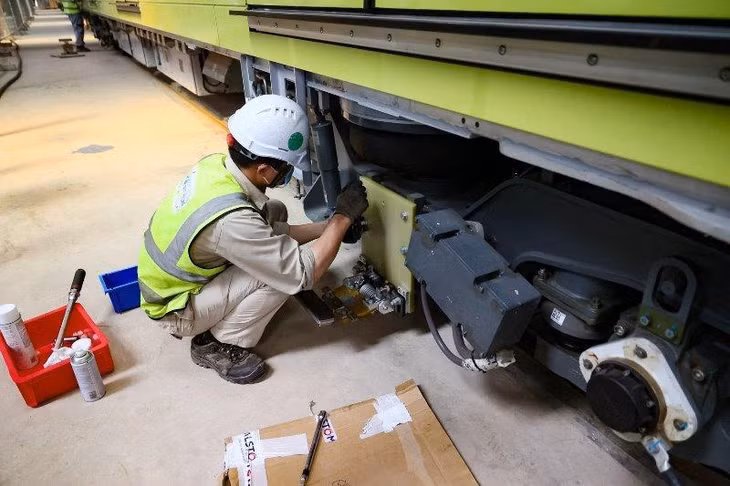 Công nhân kỹ thuật đang lắp thiết bị để hoàn thành một đoàn tàu sau khi được nhập về.