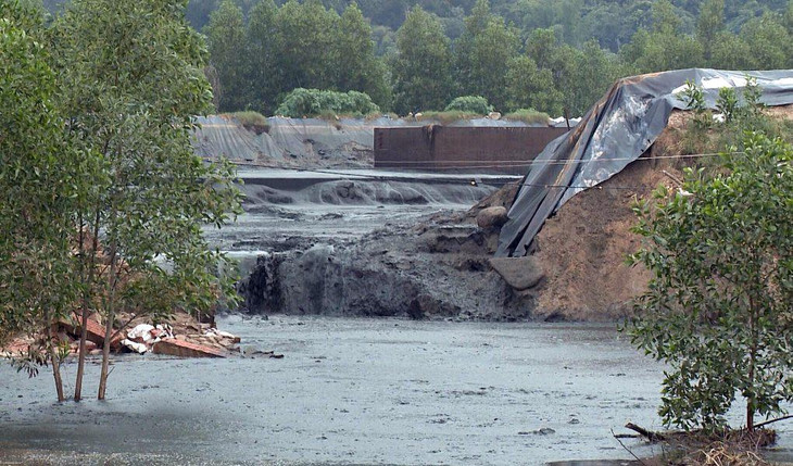 Vị trí hồ bị vỡ, chất lỏng màu đen có mùi hôi thối tràn qua khu đất liền kề