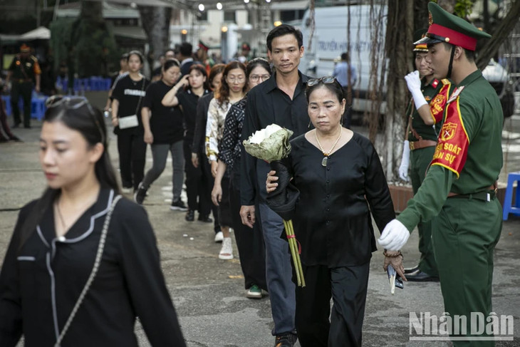 Nhiều người dân đã mang theo hoa sen để dâng lên Tổng Bí thư Nguyễn Phú Trọng.