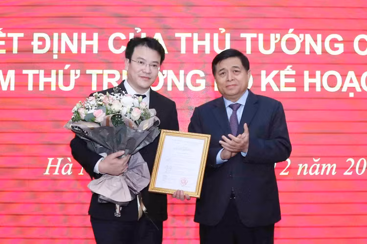Bộ trưởng Nguyễn Chí Dũng trao Quyết định và tặng hoa chúc mừng tân Thứ trưởng Trần Quốc Phương. Ảnh: Đức Trung